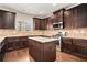 Modern kitchen with stainless steel appliances, granite countertops, and hardwood floors at 3815 Beaver Swamp Rd, Loganville, GA 30052