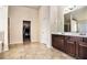 Main bathroom with double sink vanity and an entrance to a walk-in closet at 3815 Beaver Swamp Rd, Loganville, GA 30052