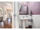 Charming powder room features a pedestal sink and attractive wood floors at 3815 Beaver Swamp Rd, Loganville, GA 30052