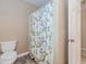 Bathroom featuring a toilet and a patterned shower curtain at 4900 Raquet Ct, Duluth, GA 30096