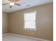 Neutral bedroom with a ceiling fan and a bright window at 4900 Raquet Ct, Duluth, GA 30096