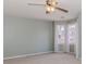 Bright bedroom with neutral walls and carpet with large, bright windows and curtains at 4900 Raquet Ct, Duluth, GA 30096