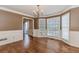 Spacious dining room with large windows, hardwood floors, and decorative wainscoting at 4900 Raquet Ct, Duluth, GA 30096