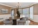 Dining room showcasing elegant wainscoting, large windows, and a stylish chandelier at 4900 Raquet Ct, Duluth, GA 30096