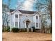 Charming two-story home features a quaint front porch, bay windows, and mature landscaping at 4900 Raquet Ct, Duluth, GA 30096