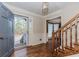 Inviting foyer with hardwood floors, staircase, detailed trim, and a view into the dining room at 4900 Raquet Ct, Duluth, GA 30096