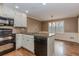 Well-lit kitchen featuring granite countertops, black appliances, and a breakfast nook at 4900 Raquet Ct, Duluth, GA 30096