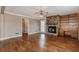 Spacious living room featuring hardwood floors, brick fireplace and built-in shelving at 4900 Raquet Ct, Duluth, GA 30096