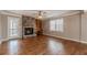 Spacious living room featuring a fireplace, hardwood floors, and natural light at 4900 Raquet Ct, Duluth, GA 30096