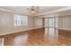 Living room featuring hardwood floors, neutral walls, and large bright windows at 4900 Raquet Ct, Duluth, GA 30096