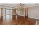 Open living room with hardwood floors and large windows letting in natural light at 4900 Raquet Ct, Duluth, GA 30096