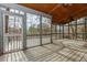 Screened porch with a wood ceiling and plank floors at 4900 Raquet Ct, Duluth, GA 30096