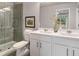 Bathroom featuring a double sink vanity, framed mirror, and a tiled glass enclosed shower at 5603 Hislop Ln # 79, Mableton, GA 30126