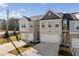 Attractive townhome exterior featuring a two-car garage, brick facade, and well-manicured landscaping at 5603 Hislop Ln # 79, Mableton, GA 30126