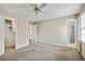 Open bedroom featuring carpet flooring, ceiling fan, and closet space at 6700 Roswell Rd # 11B, Atlanta, GA 30328