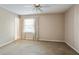 Bright bedroom featuring neutral walls and a large window with curtains at 6700 Roswell Rd # 11B, Atlanta, GA 30328