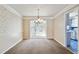 Dining room featuring wallpaper, chandelier lighting, and entry to the kitchen at 6700 Roswell Rd # 11B, Atlanta, GA 30328