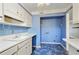 Kitchen area with retro blue tile flooring and updated countertops at 6700 Roswell Rd # 11B, Atlanta, GA 30328