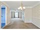 Spacious living room featuring large windows and a classic chandelier at 6700 Roswell Rd # 11B, Atlanta, GA 30328