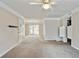 Open-concept living room with neutral paint and carpet, leading to dining area at 6700 Roswell Rd # 11B, Atlanta, GA 30328