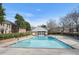 A large community swimming pool surrounded by brick buildings and green hedges at 6700 Roswell Rd # 11B, Atlanta, GA 30328