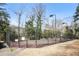 Fenced tennis court surrounded by trees offering a great recreational opportunity at 6700 Roswell Rd # 11B, Atlanta, GA 30328