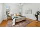 Comfortable bedroom with hardwood floors, two windows, and stylish decor at 1198 Piedmont Ne Ave # 103, Atlanta, GA 30309