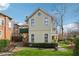 Charming two-story home with yellow siding, landscaped yard, and a brick driveway, creating a welcoming curb appeal at 1198 Piedmont Ne Ave # 103, Atlanta, GA 30309