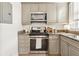 Modern kitchen features stainless steel appliances, granite countertops, and gray cabinetry at 1198 Piedmont Ne Ave # 103, Atlanta, GA 30309