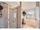 Bright bathroom featuring a glass shower and a separate soaking tub beneath a window at 1756 Hedington Ct, Lawrenceville, GA 30045