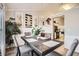 Elegant dining room showcasing modern lighting, pineapple wall decor, and a view of the kitchen area at 1756 Hedington Ct, Lawrenceville, GA 30045