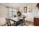 Chic dining room featuring modern decor, stylish lighting, and a dark wood table set for four at 1756 Hedington Ct, Lawrenceville, GA 30045