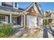 Close-up of the home's entrance, highlighting the brickwork, two-car garage, and charming front porch at 1756 Hedington Ct, Lawrenceville, GA 30045