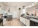 Bright kitchen featuring white cabinets, stainless steel appliances, and a stylish breakfast nook at 1756 Hedington Ct, Lawrenceville, GA 30045