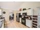 Well-lit kitchen with stainless steel appliances, light-colored cabinets, and wooden floors at 1756 Hedington Ct, Lawrenceville, GA 30045