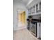 Basement area with a wet bar featuring a wine fridge, cabinets, and tile flooring at 3117 W Roxboro Ne Rd, Atlanta, GA 30324