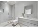 Modern bathroom featuring a glass-enclosed shower, white vanity with ample counter space, and neutral tile flooring at 3117 W Roxboro Ne Rd, Atlanta, GA 30324