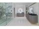 Luxurious bathroom featuring double vanities, marble countertops, and a glass-enclosed shower at 3117 W Roxboro Ne Rd, Atlanta, GA 30324