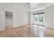 Bright bedroom featuring a ceiling fan, hardwood floors, and a large window at 3117 W Roxboro Ne Rd, Atlanta, GA 30324