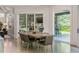 Open-concept dining area with sleek wood table, modern chairs, and sliding glass doors at 3117 W Roxboro Ne Rd, Atlanta, GA 30324