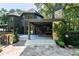 Rear exterior view of the home showcasing a covered patio and stone accents at 3117 W Roxboro Ne Rd, Atlanta, GA 30324