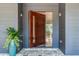 Modern front door with a sleek design, complemented by stone flooring and elegant exterior lighting at 3117 W Roxboro Ne Rd, Atlanta, GA 30324