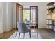 Bright home office with glass top desk, built-in shelving, and French doors to outside porch at 3117 W Roxboro Ne Rd, Atlanta, GA 30324