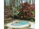 Backyard pool and spa are surrounded by lush landscaping and a stone patio at 3117 W Roxboro Ne Rd, Atlanta, GA 30324