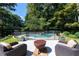 Backyard pool with a stone waterfall feature, surrounded by mature trees and lush landscaping at 3117 W Roxboro Ne Rd, Atlanta, GA 30324