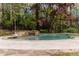 Beautiful pool area with stone waterfall feature and lush landscaping, perfect for relaxation at 3117 W Roxboro Ne Rd, Atlanta, GA 30324