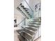 Elegant staircase featuring glass railings and hardwood steps, showcasing a modern and open design at 3117 W Roxboro Ne Rd, Atlanta, GA 30324