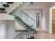 Modern staircase with glass railing and wooden steps leading to the upper level of the home at 3117 W Roxboro Ne Rd, Atlanta, GA 30324