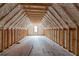 Unfinished attic with exposed wood beams and spray foam insulation, showcasing potential space at 628 Sandhill Hickory Level Rd, Carrollton, GA 30116