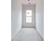 Narrow bathroom featuring unfinished walls and natural light from a central window at 628 Sandhill Hickory Level Rd, Carrollton, GA 30116